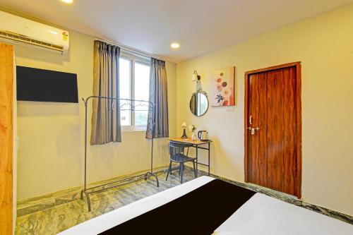 a room with a wooden door and a table at Super Townhouse CASA GRAND ECIL in Hyderabad