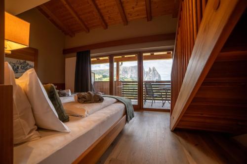 a bedroom with a bed with a view of a mountain at Berghotel Zorzi in Alpe di Siusi
