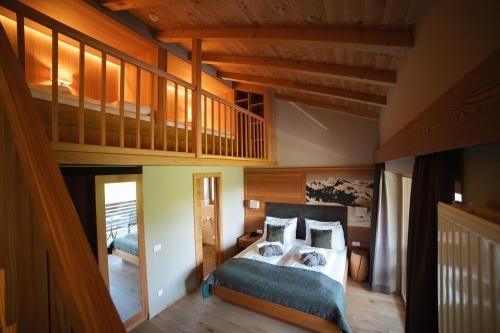 a bedroom with a bed and a loft at Berghotel Zorzi in Alpe di Siusi