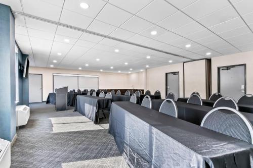 a conference room with rows of chairs and tables at Comfort Inn & Suites Grand Blanc-Flint in Grand Blanc