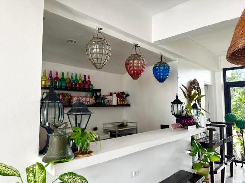 a room with a counter with several lights and plants at BACKDOOR VILLA in Baler