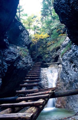 a set of stairs leading down to a waterfall at Chata Piecky in Hrabušice