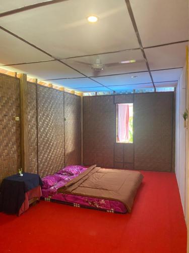 a room with a bed in a room with a window at Green View Homestay & Jungle Trekking in Bukit Lawang