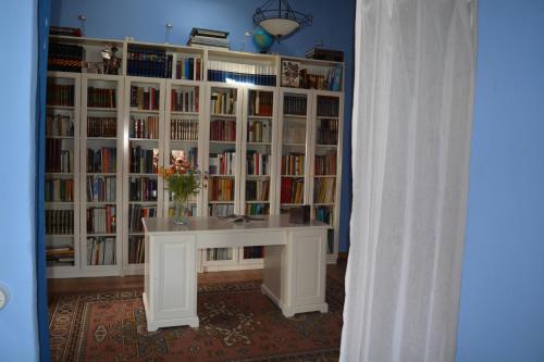 a room with a book shelf filled with books at Casa Rural FuenteVieja in La Mata de los Olmos