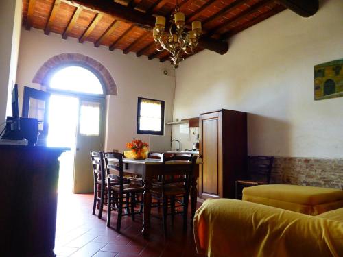 a kitchen and dining room with a table and chairs at Fattoria di Colleoli in Colleoli