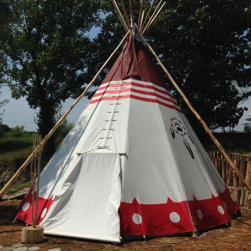 a red and white teepee tent sitting on the ground at Zagreb Camp Bungalows in Rakitje