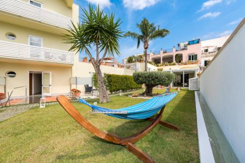 a hammock in the yard of a house at Marina 10 Boutique&Design Hotel in Ischia