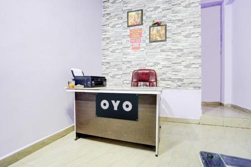 einen Schreibtisch mit einem Schild auf einem Zimmer in der Unterkunft SPOT ON Hotel Royal Inn in Chandrapur