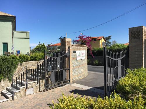 a wrought iron gate in front of a house at Villamir B&B in Albenga