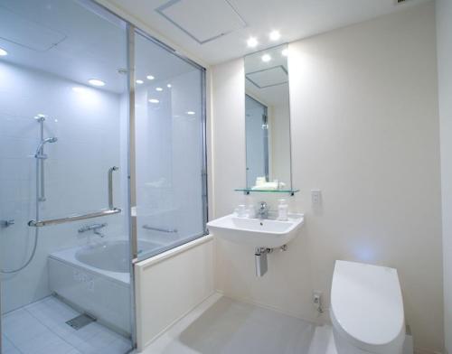 a bathroom with a toilet and a sink and a shower at Hotel Bestland in Tsukuba
