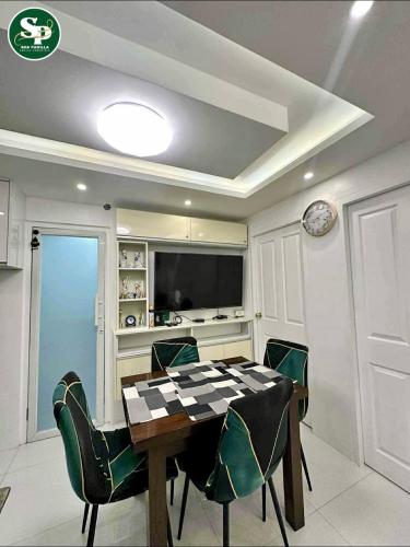 a dining room with a table and green chairs at D' Centro Inn in Davao City