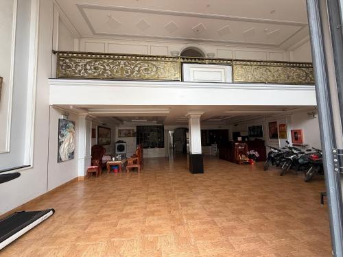 a large room with tables and chairs and a balcony at Hotel 5 Sao in Bến Lức