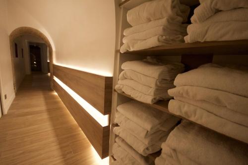 a stack of towels on a shelf in a room at Hôtel Brésil Opéra SPA in Paris