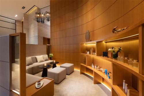 a living room with a couch and a table at Conrad Seoul in Seoul