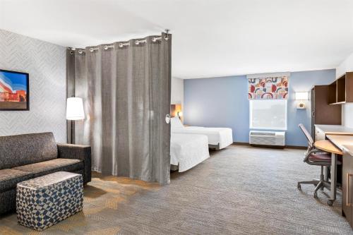 a hotel room with a bed and a desk at Home2 Suites By Hilton Youngstown in Youngstown