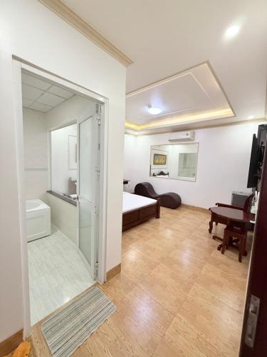 a room with a bed and a sliding glass door at Hotel 5 Sao in Bến Lức