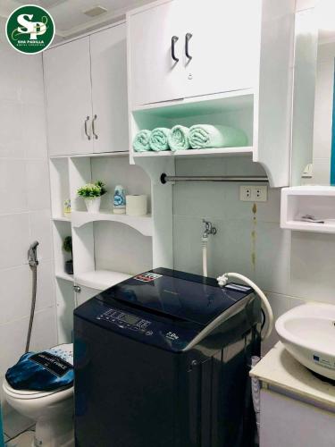 a small bathroom with a toilet and a sink at JHS Condo in Davao City