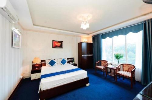 a hotel room with a bed and a table and chairs at Hanoi Dai Duong Hotel 1 in Hanoi