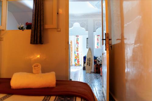 a view of a room with a bed and a hallway at Aourir Waves Surf House in Aourir