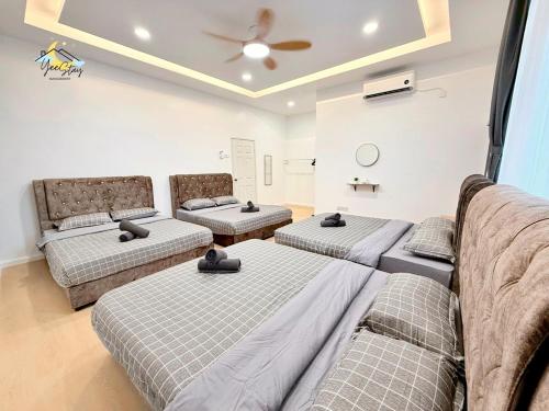 a living room with two beds and a couch at UjongPasir18paxLanded10minstoJonker in Melaka