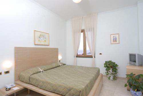 Кровать или кровати в номере Hotel Villa Carolina