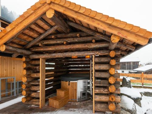 a log cabin with a stove in the middle at Farmhouse in Bramberg with Natural Pond in Dorf