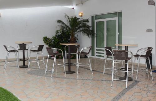 a group of tables and chairs on a patio at Hotel Magico Inn in Cuautla Morelos