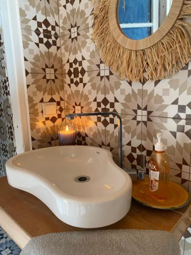 a bathroom with a white sink and a mirror at Aourir Waves Surf House in Aourir