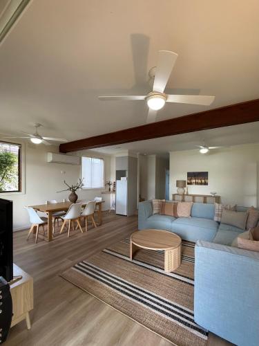 a living room with a couch and a table at Golden Mile - On the Waterfront in Bundalong