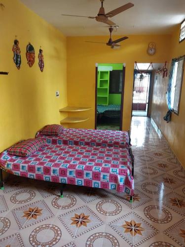 a bedroom with a large bed in a room at Night Stay Guest House 8PM to 8AM Non AC and No Car Parking Near Kamatchi Amman Temple in Kanchipuram