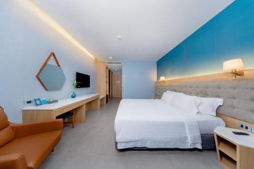 a hotel room with a bed and a couch at BlueSotel Krabi AoNang Beach in Ao Nang Beach