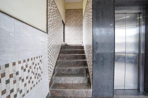 a staircase in a room with a glass door at FabHotel Millennium Suites in Bengaluru