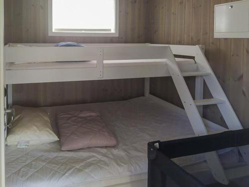 a white bunk bed in a small room at Stylish Cabin Experience In Beautiful Surroundings in Færvik