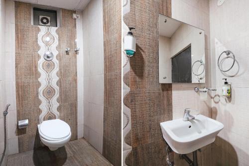 a bathroom with a toilet and a sink at FabHotel Millennium Suites in Bengaluru