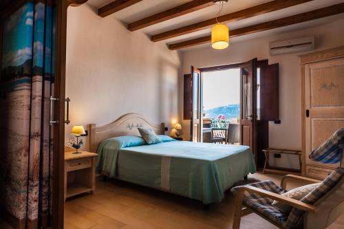 a bedroom with a bed and a window and a chair at Residenza Petrera in Muravera