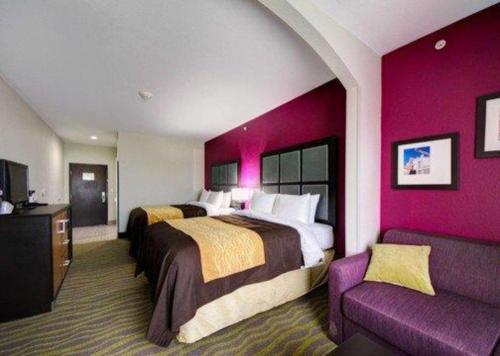 a hotel room with two beds and a couch at Comfort Inn & Suites Tulsa I-44 West - Rt 66 in Tulsa