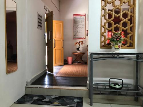 a view of a hallway with a door and a table at Seri Pengkalan Guest House in Bachok