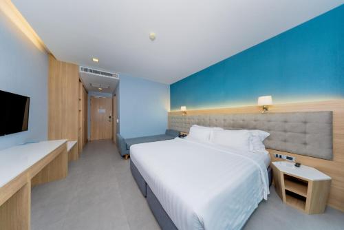 a hotel room with two beds and a tv at BlueSotel Krabi AoNang Beach in Ao Nang Beach