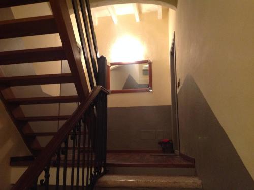 a hallway with a staircase with a mirror on the wall at La casa di Enea in Goito