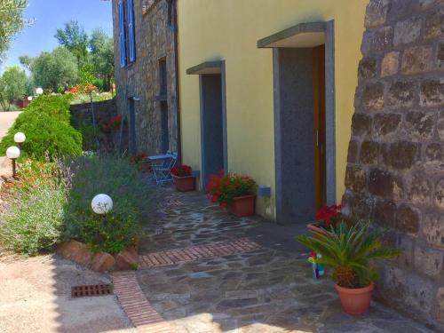 a stone walkway next to a building with potted plants at Villa Li Schisani in Sorrento