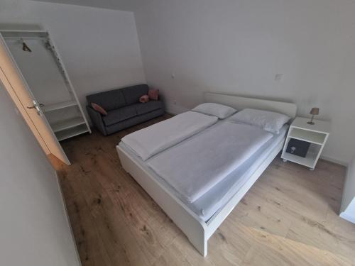 a small bedroom with a bed and a couch at Antica Dolina in Postojna