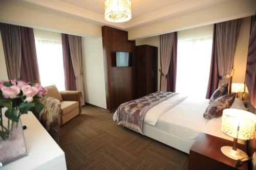 a hotel room with a bed and a couch at Vurna Butik Hotel in Trabzon