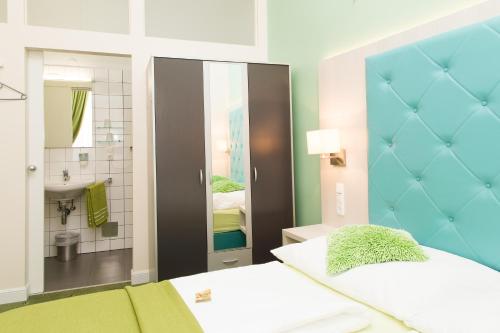 a small room with a bed and a bathroom at Very Central, 5 min to city center, Self Check In in Vienna