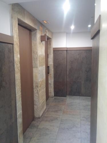 a hallway with a door and a tile floor at Pensión Saint Mateo in Logroño