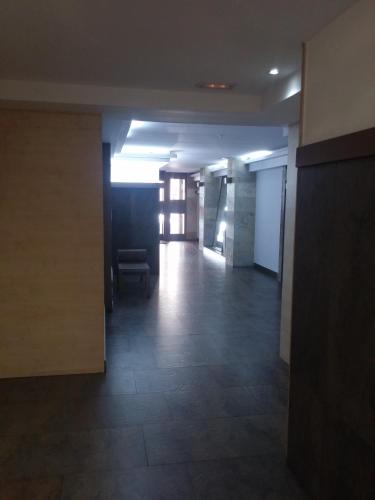 an empty hallway of an office building with a chair at Pensión Saint Mateo in Logroño