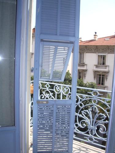 an open door to a balcony with a view of a building at Villa Saint Hubert in Nice