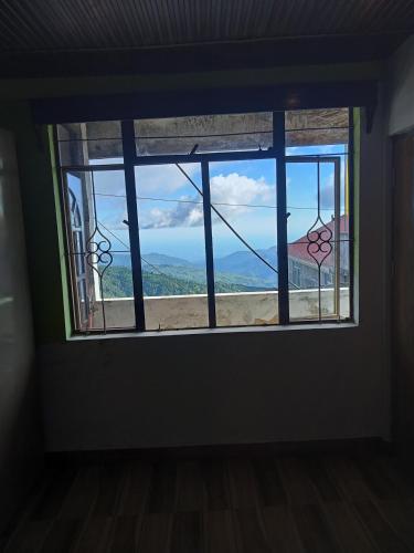 a window in a room with a view at Agarwal Home Stay in Jālāpahār