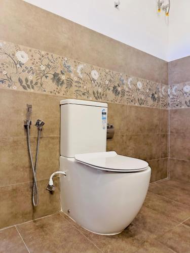 a bathroom with a toilet and a shower at The Ridge Colonial Villa - Ahangama in Ahangama