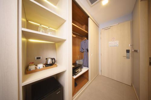 a walk in pantry with a door to a kitchen at BlueSotel Krabi AoNang Beach in Ao Nang Beach