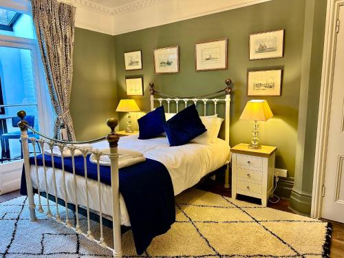 a bedroom with a bed and two lamps and a window at The Garden Flat - Newly Refurbished Throughout in Dorchester